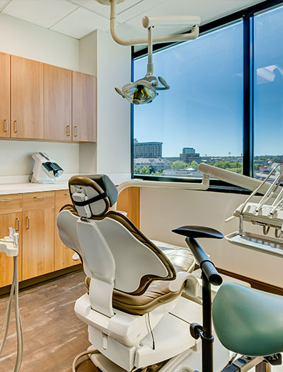 Happy woman sitting in dental chair