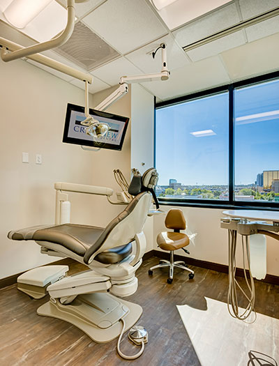 Happy woman sitting in dental chair